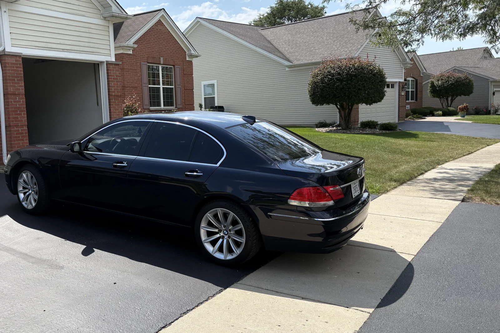 Cloud 9 black BMW 750i sedan, side view