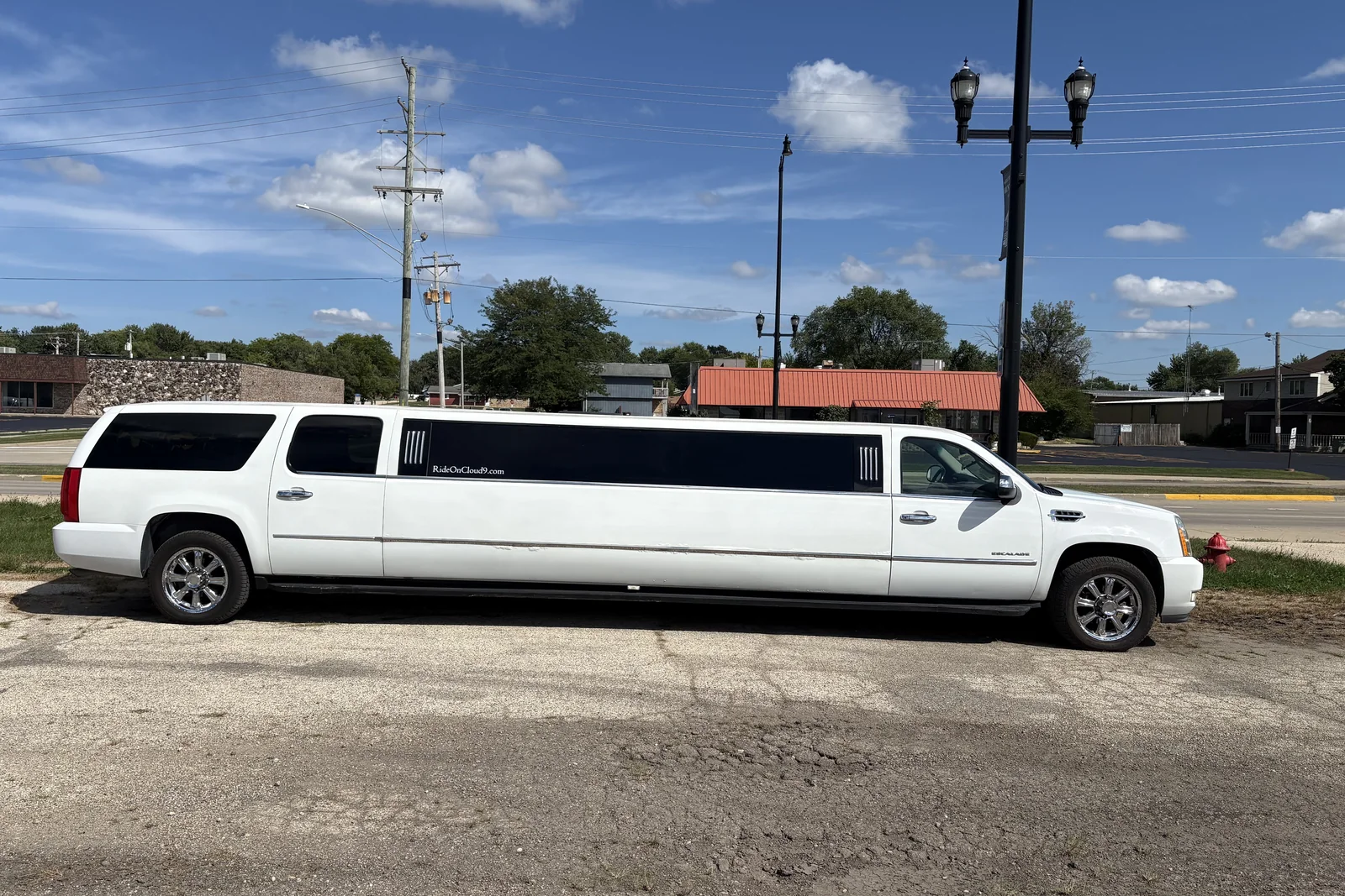 Cloud 9 white Cadillac Escalade stretch limousine, full side view, Huntley Illinois