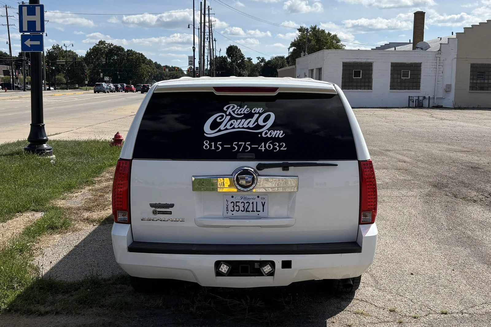 Rear of the Cloud 9 stretch limousine showing the RideOnCloud9.com decal and phone number